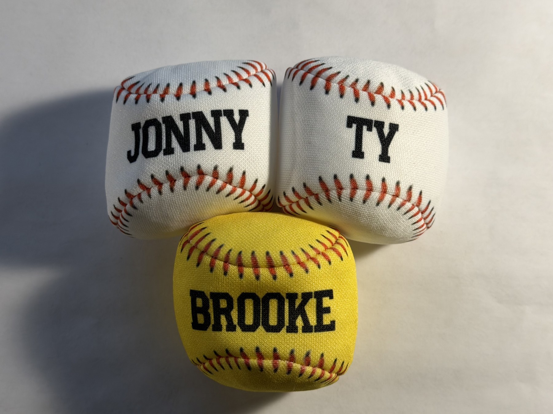Three baseball- and softball-print hacky sacks personalized Jonny, Ty, and Brooke