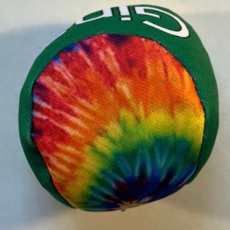 Tie-dye hacky sack with a green trim, hand-stitched